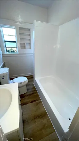 a bathroom with a tub and toilet