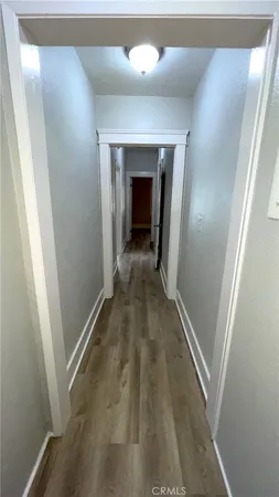 a view of a hallway with wooden floor