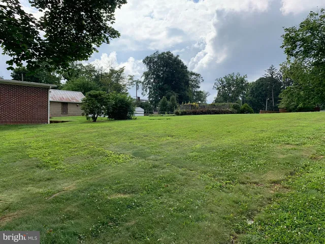 a view of a field of a house with a big yard