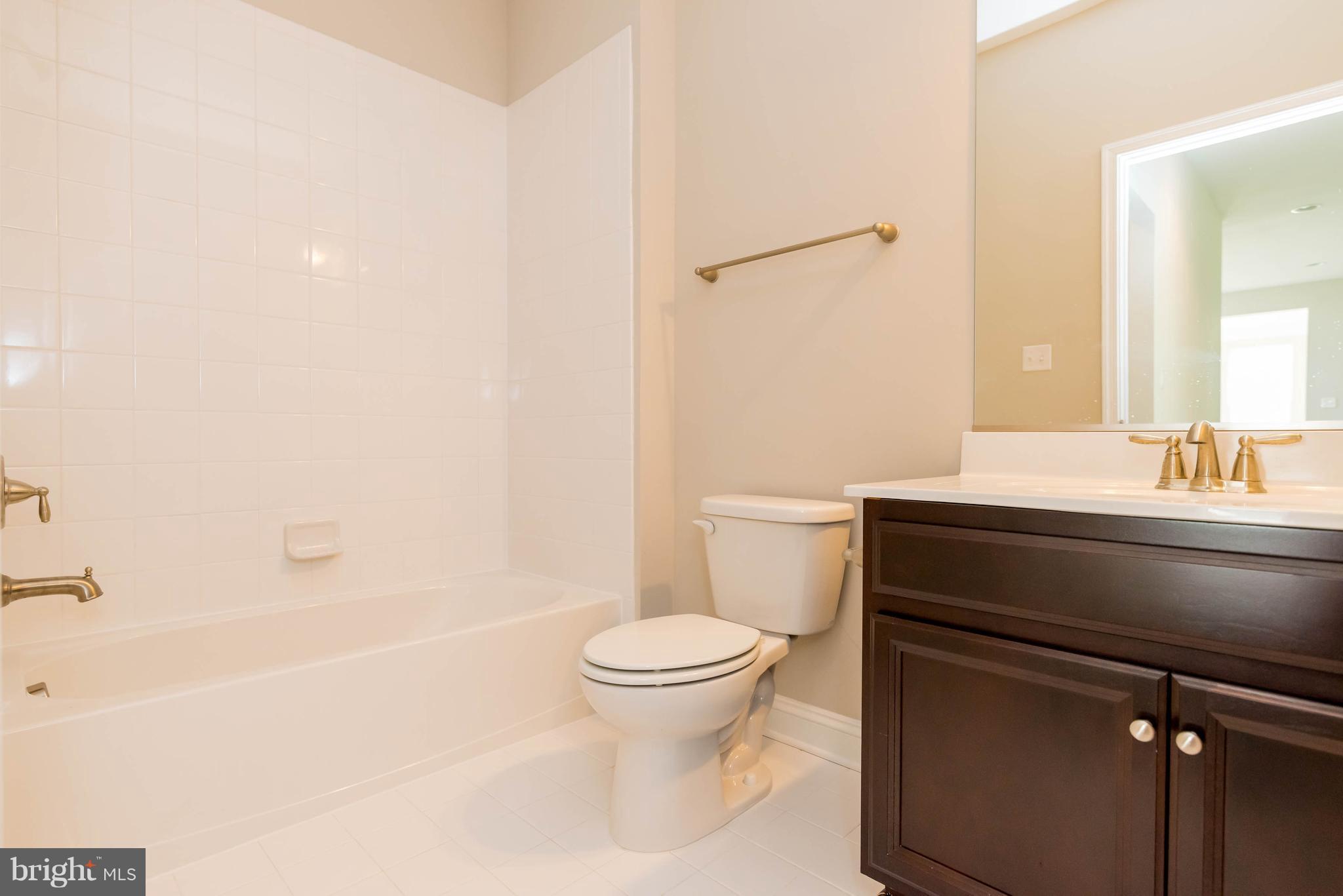4229 Perry Hall Road Perry Hall, MD 21128 - Photo 13 of 30 a bathroom with a sink a toilet and a bathtub