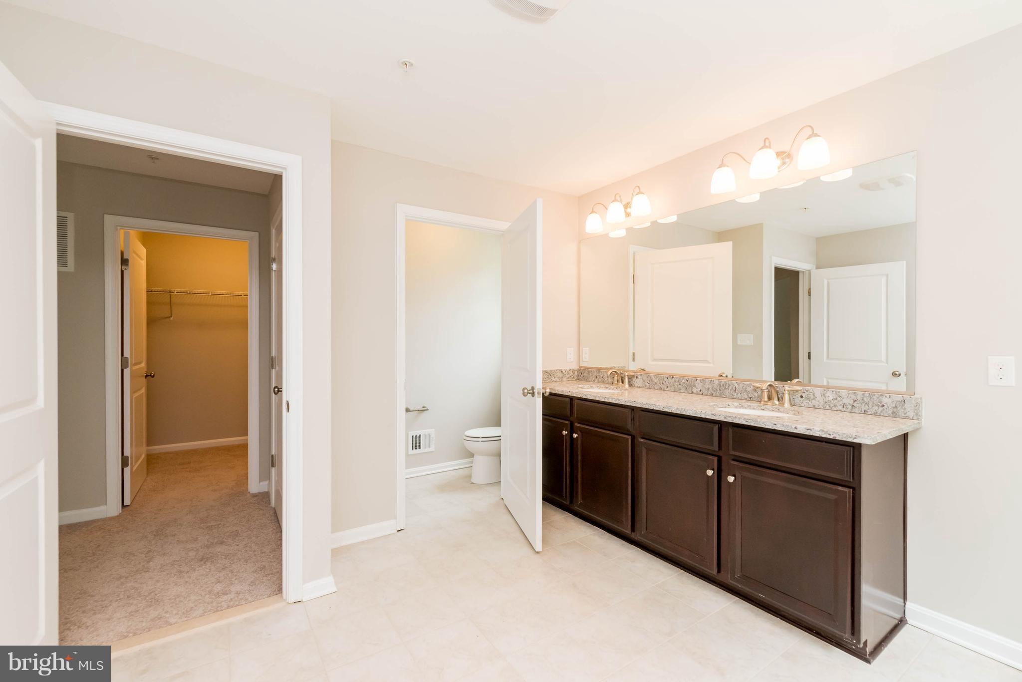 4229 Perry Hall Road Perry Hall, MD 21128 - Photo 18 of 30 a spacious bathroom with a granite countertop sink mirror and a