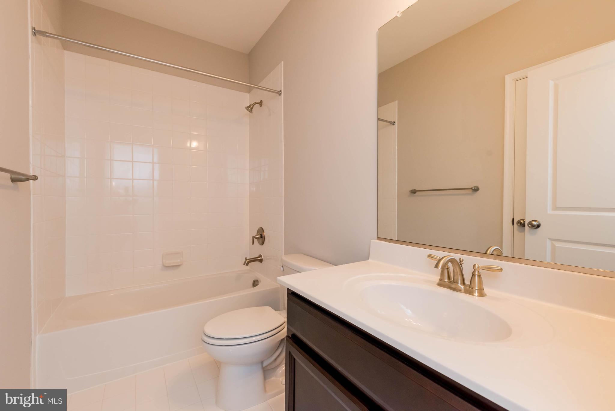 4229 Perry Hall Road Perry Hall, MD 21128 - Photo 26 of 30 a bathroom with a sink a toilet and shower