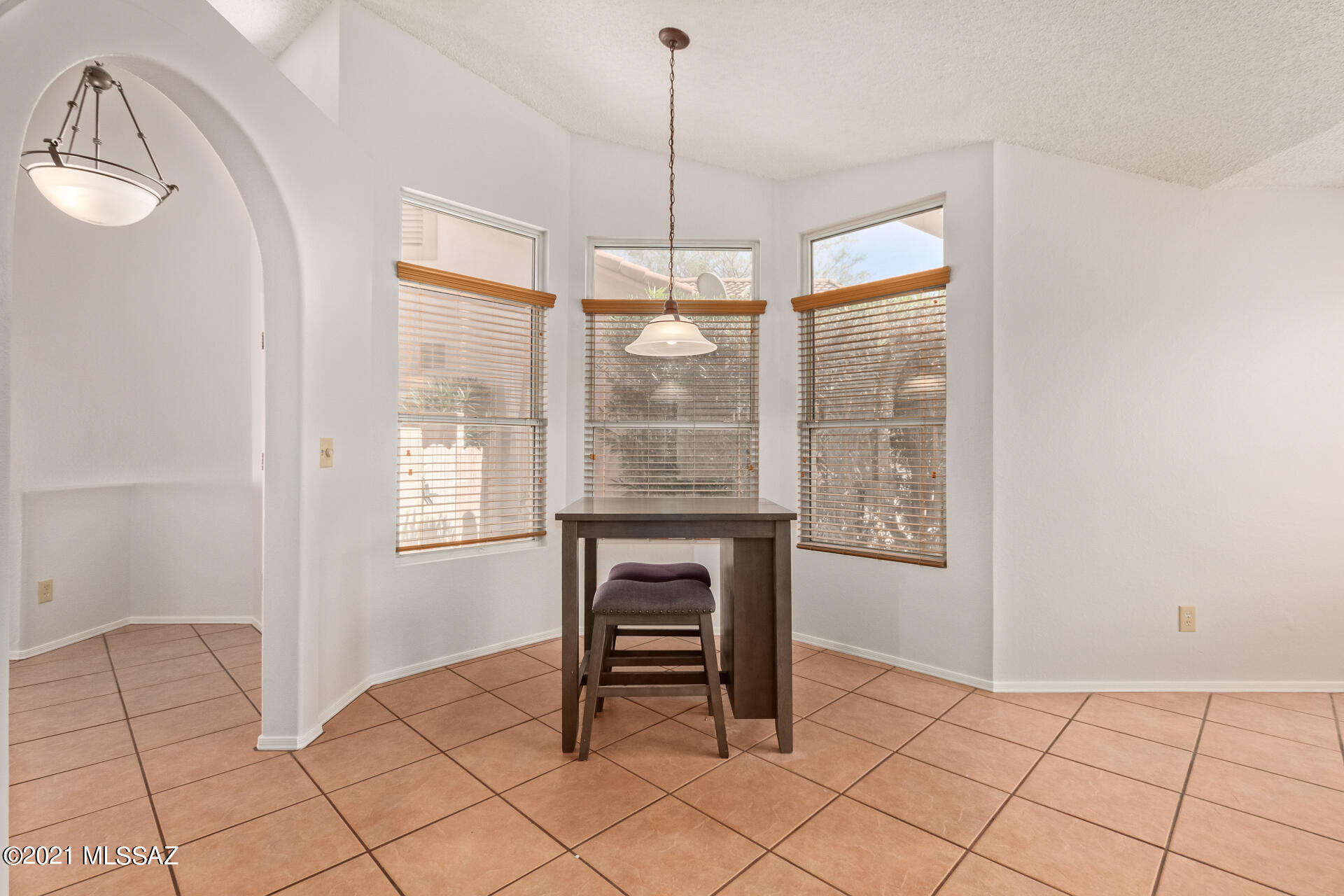 3034 West Sky Ranch Trail Tucson, AZ 85742 - Photo 9 of 27 a dining room with furniture and window