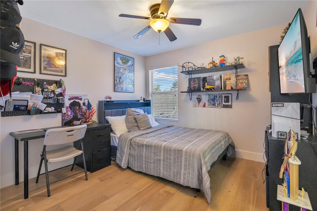 13263 Strode Lane Windermere, FL 34786 - Photo 31 of 53 a bedroom with a bed and a chandelier