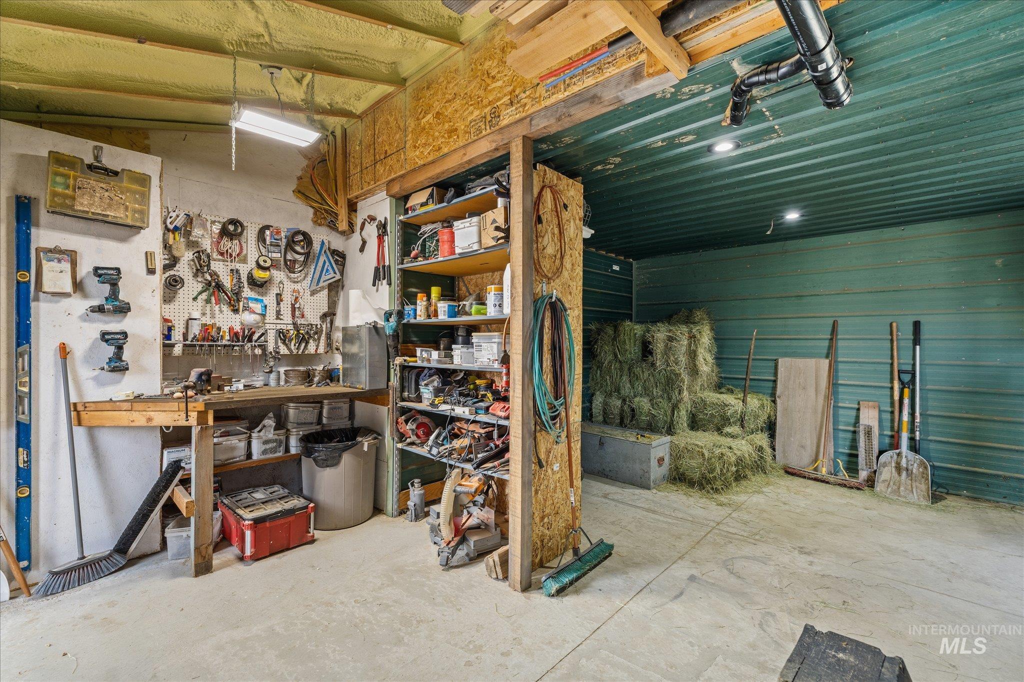 1140 Edgemont Road Emmett, ID 83617 - Photo 40 of 50 Spacious utility area featuring a concrete floor, built-in workbench, and overhead fluorescent lighting