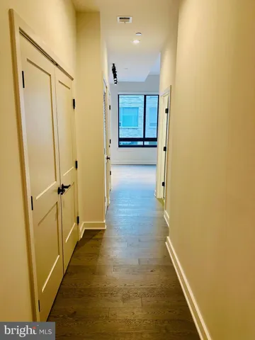 a view of a hallway with wooden floor