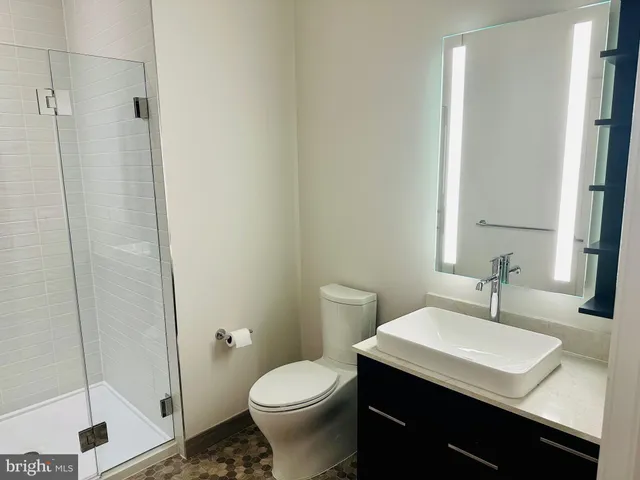 a bathroom with a sink toilet and shower
