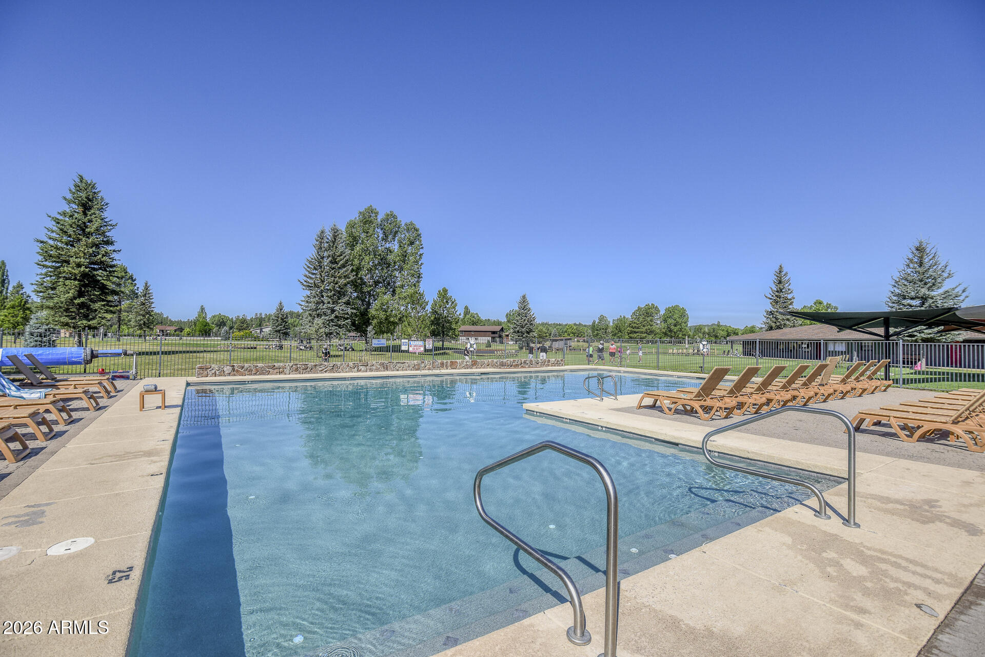 17795 Hopi Road, Unit 51 Munds Park, AZ 86017 - Photo 28 of 58 a view of a swimming pool with a lounge chair