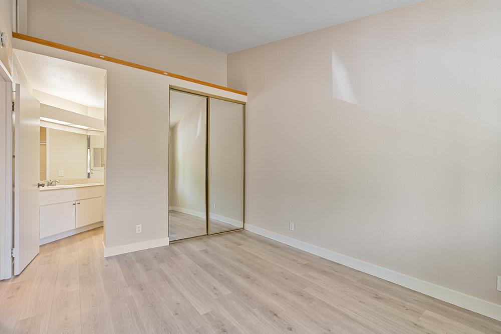 331 Shadow Run Drive San Jose, CA 95110 - Photo 12 of 25 an empty room with wooden floor and closet