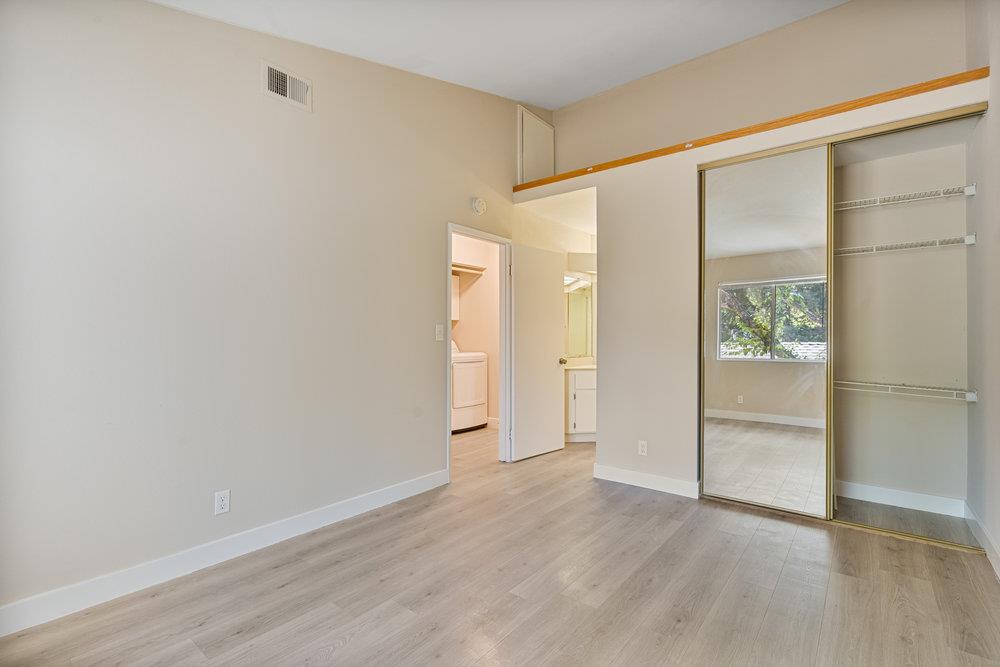 331 Shadow Run Drive San Jose, CA 95110 - Photo 13 of 25 an empty room with wooden floor and windows