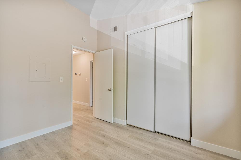 331 Shadow Run Drive San Jose, CA 95110 - Photo 16 of 25 a view of an empty room with wooden floor and entryway