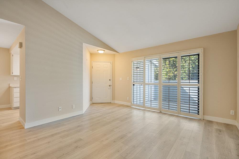 331 Shadow Run Drive San Jose, CA 95110 - Photo 3 of 25 an empty room with wooden floor and windows