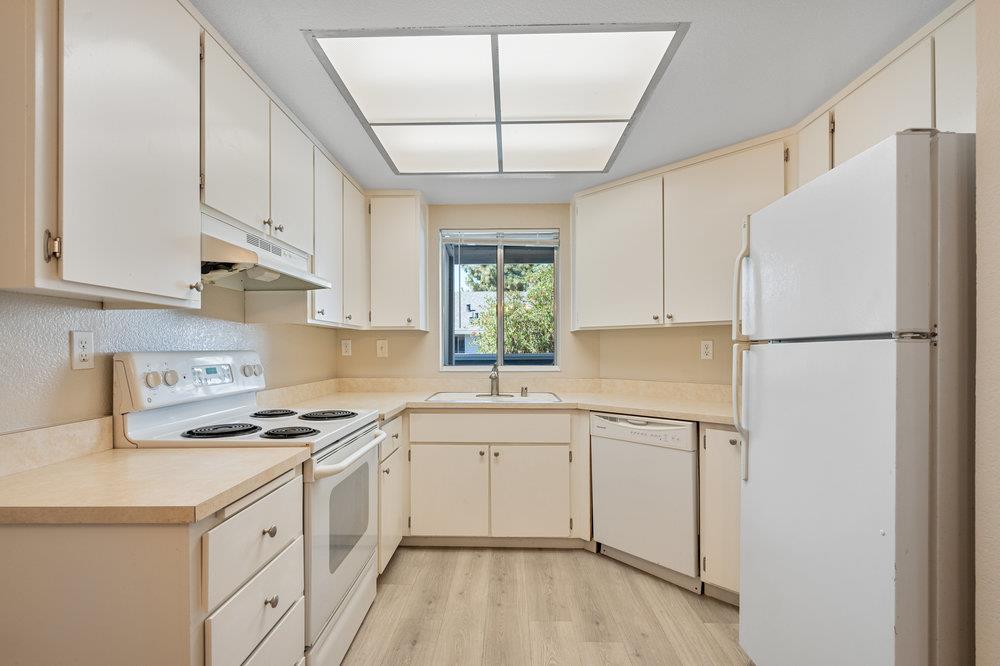 331 Shadow Run Drive San Jose, CA 95110 - Photo 8 of 25 a kitchen with white cabinets and white appliances