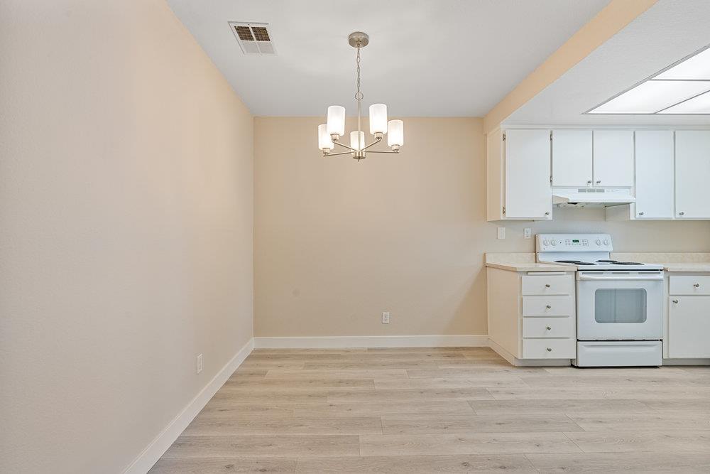 331 Shadow Run Drive San Jose, CA 95110 - Photo 9 of 25 a view of a kitchen with stove and white cabinets