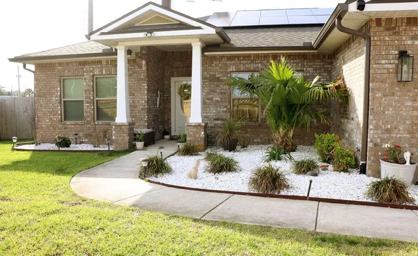 a front view of a house with garden