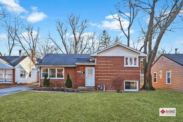 a front view of a house with a garden