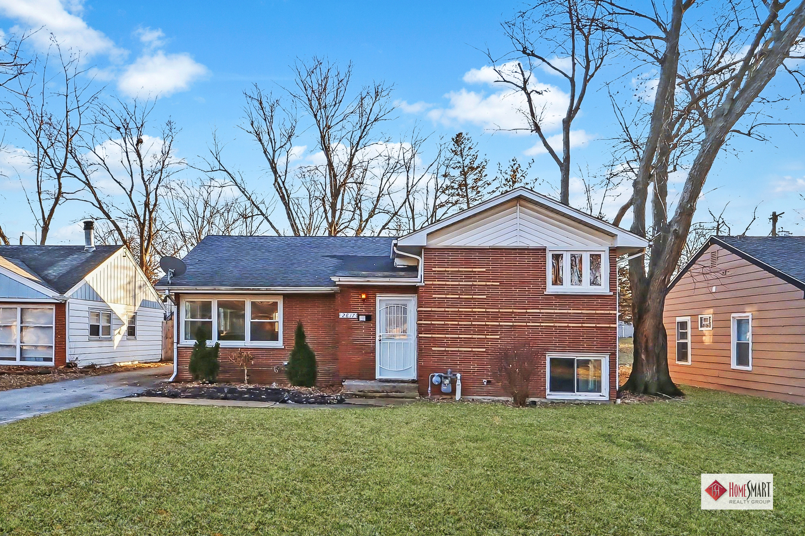 a front view of a house with a garden