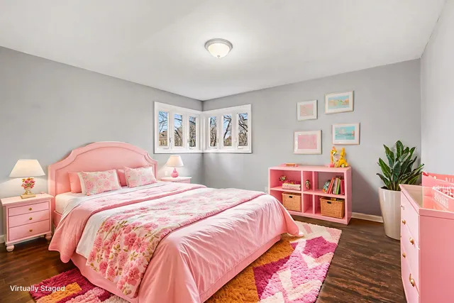a bedroom with a bed and a potted plant