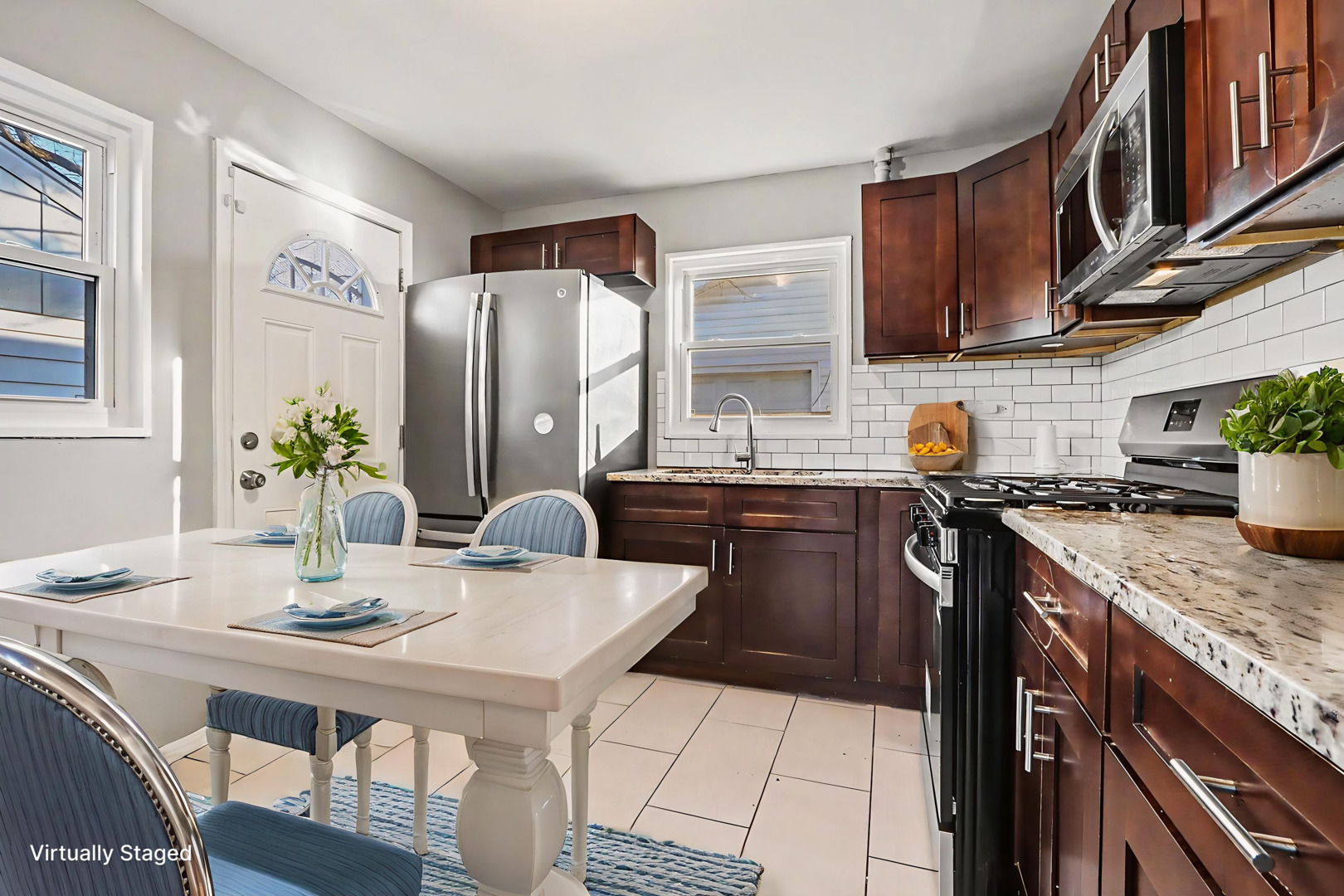 2817 173rd Street Hazel Crest, IL 60429 - Photo 2 of 23 a kitchen with stainless steel appliances granite countertop a sink a stove a dining table and chairs