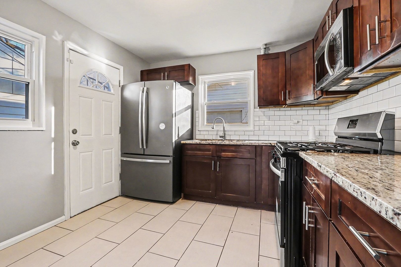 2817 173rd Street Hazel Crest, IL 60429 - Photo 3 of 23 a kitchen with stainless steel appliances granite countertop a refrigerator stove and sink