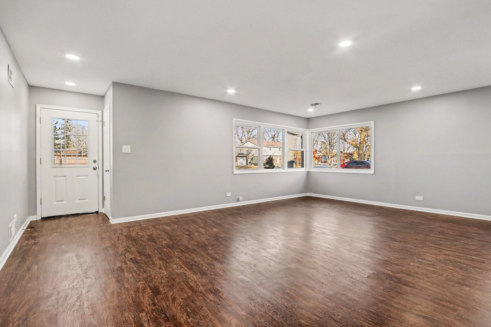 2817 173rd Street Hazel Crest, IL 60429 - Photo 7 of 23 a view of an empty room with a window and wooden floor