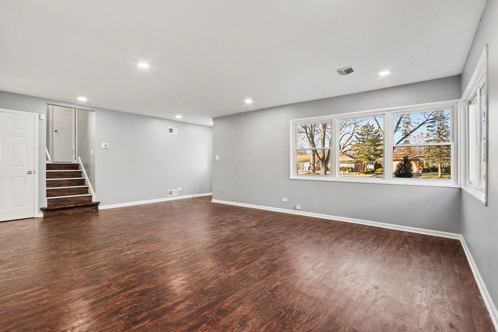2817 173rd Street Hazel Crest, IL 60429 - Photo 8 of 23 a view of an empty room with wooden floor and painting on the wall