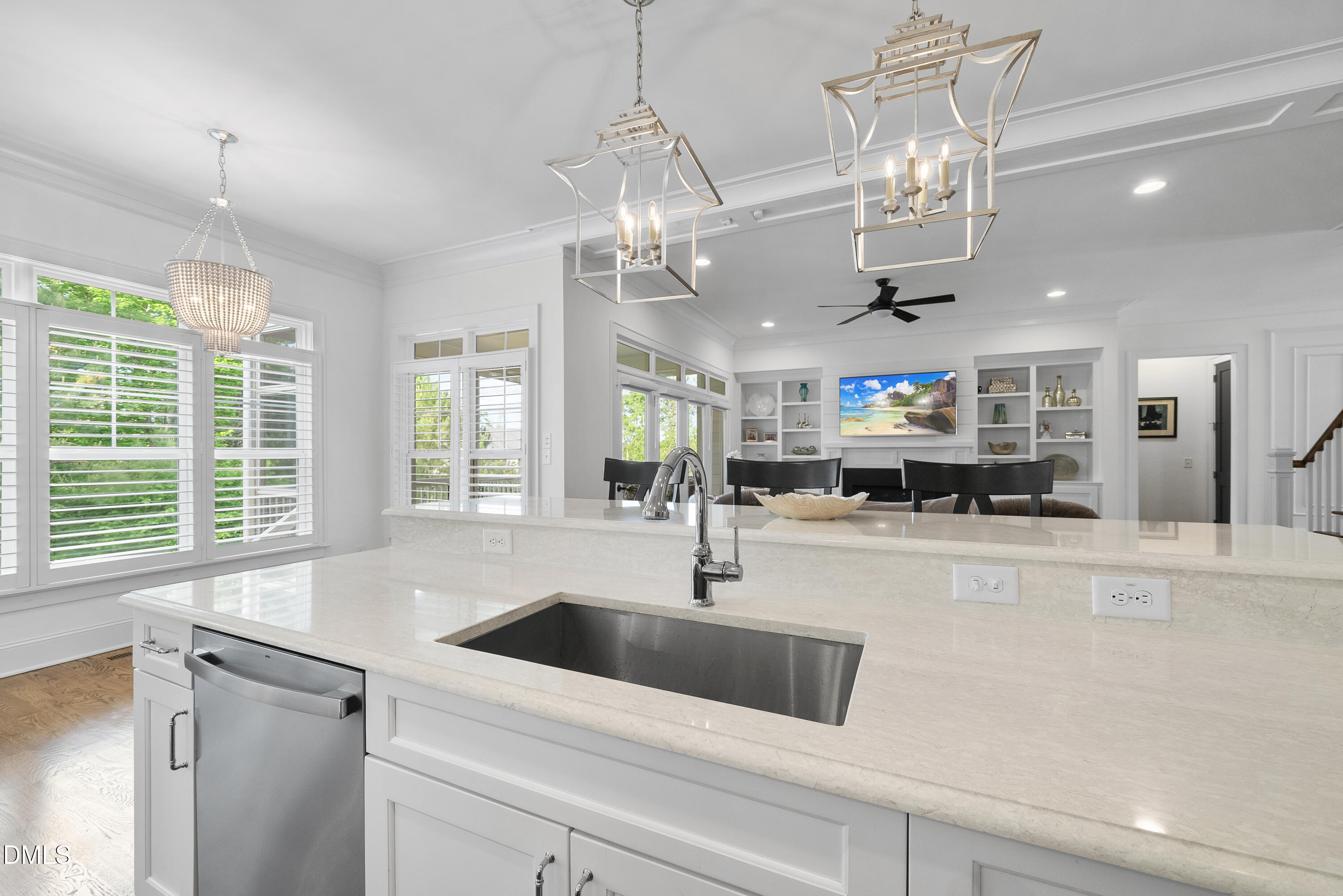 5109 Wainscott Way Raleigh, NC 27612 - Photo 13 of 52 a kitchen with stainless steel appliances granite countertop a sink a counter space and a chandelier