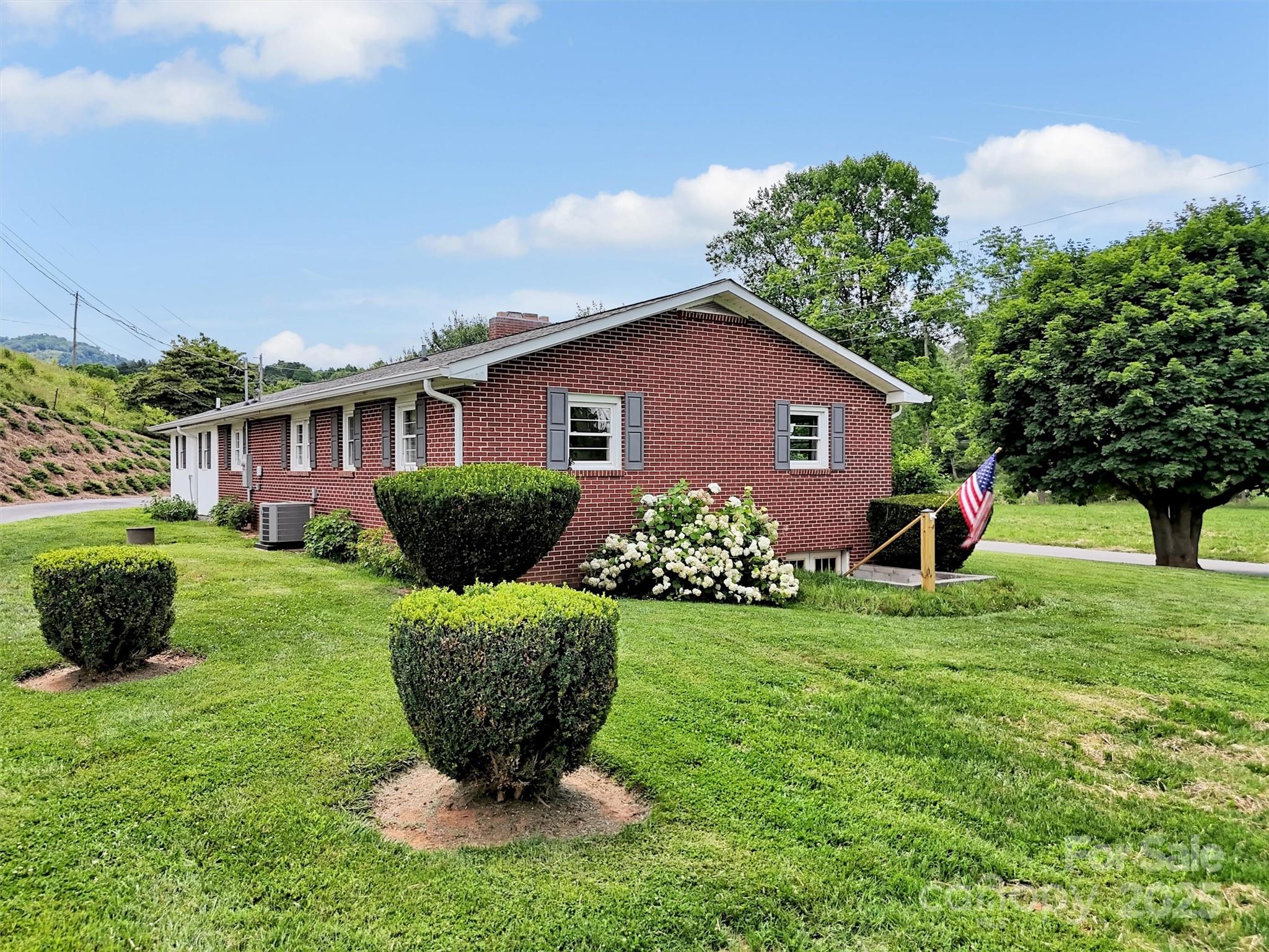 463 Golf Course Road Clyde, NC 28721 - Photo 35 of 41 a view of a house with a yard and potted plants
