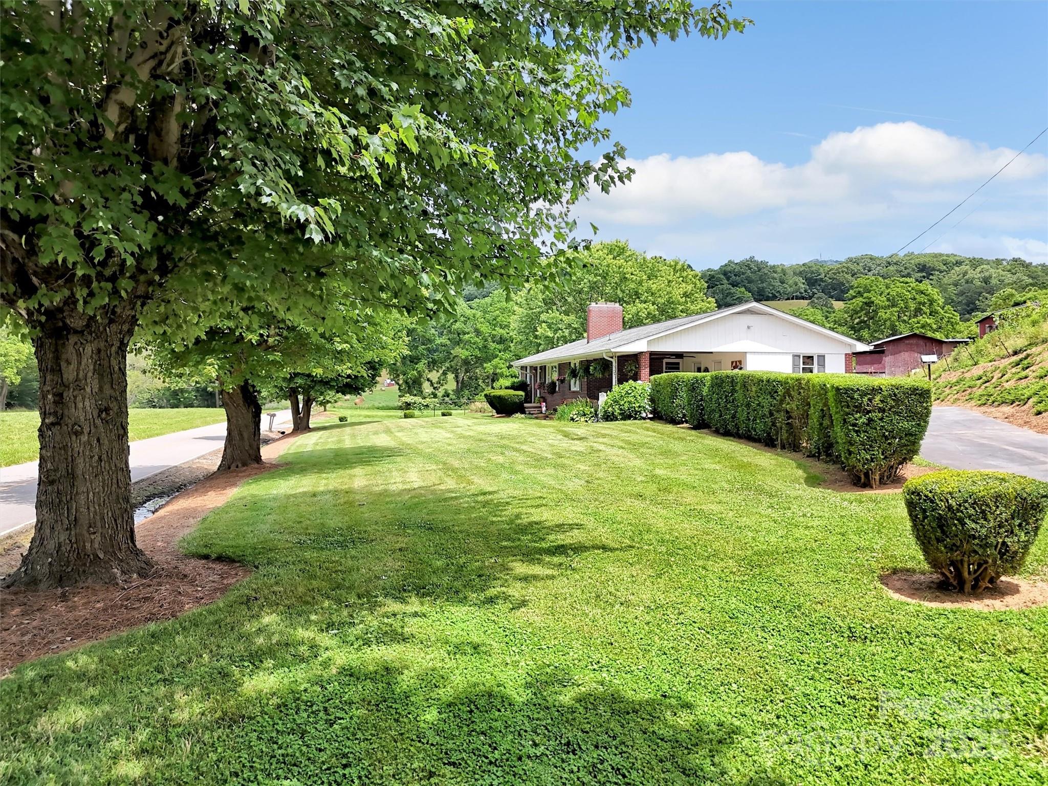 463 Golf Course Road Clyde, NC 28721 - Photo 38 of 41 a view of an outdoor space and a yard