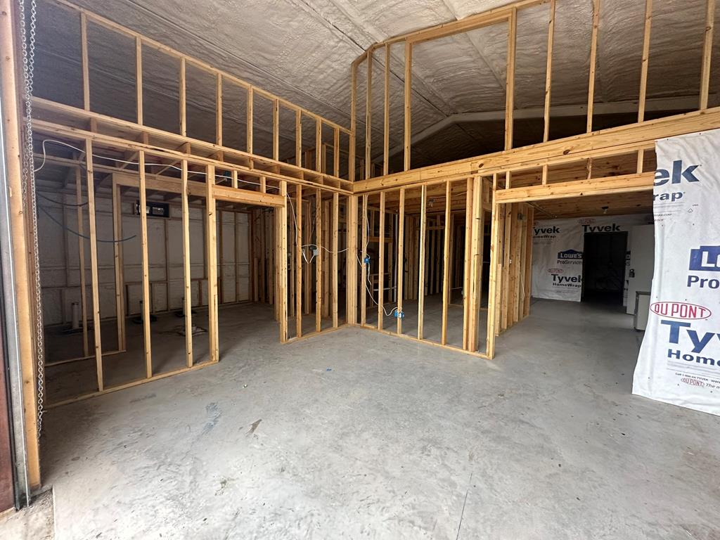 52 Timbers Drive Leakey, TX 78873 - Photo 19 of 28 a view of an empty room with wooden floor and a window