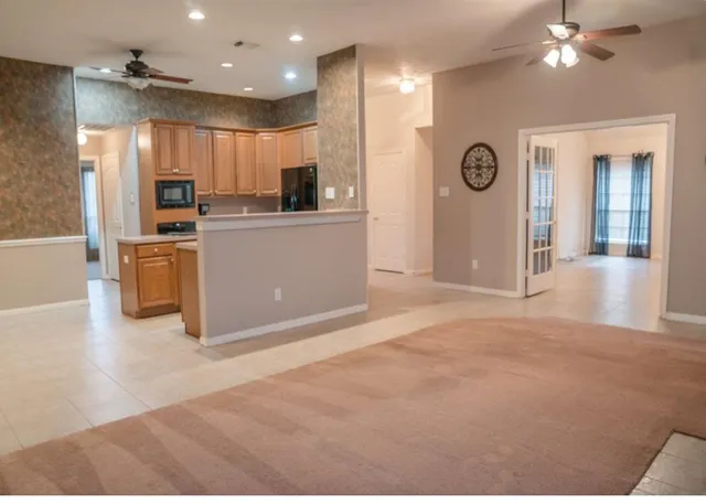 a view of a kitchen with a sink and refrigerator