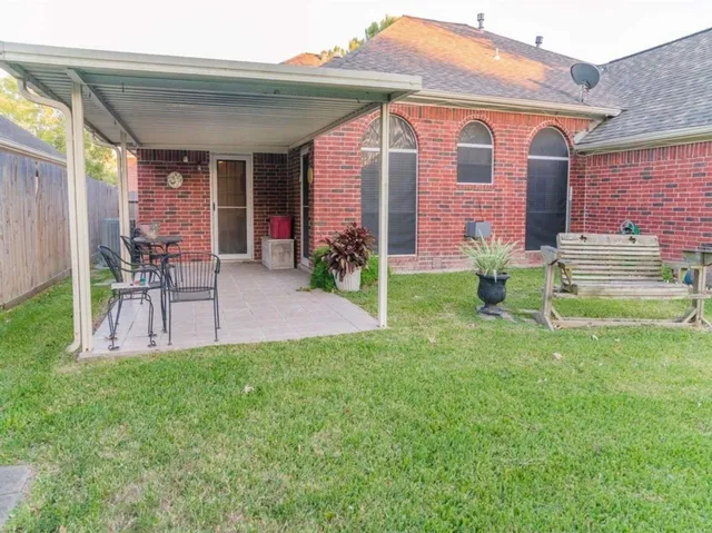 a front view of house with yard and outdoor seating