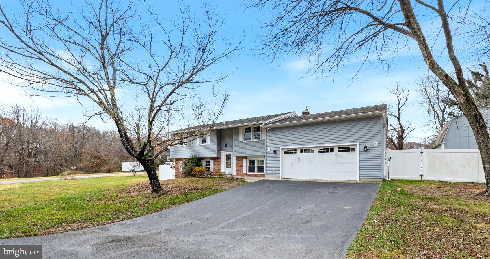 1302 Squire Lane Dunkirk, MD 20754 - Photo 1 of 31 a view of a white house with a big yard and large tree