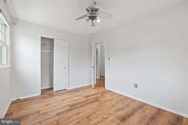 a view of a room with a ceiling fan and a window