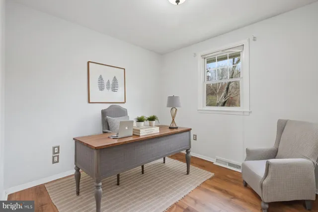 a workspace with furniture and wooden floor
