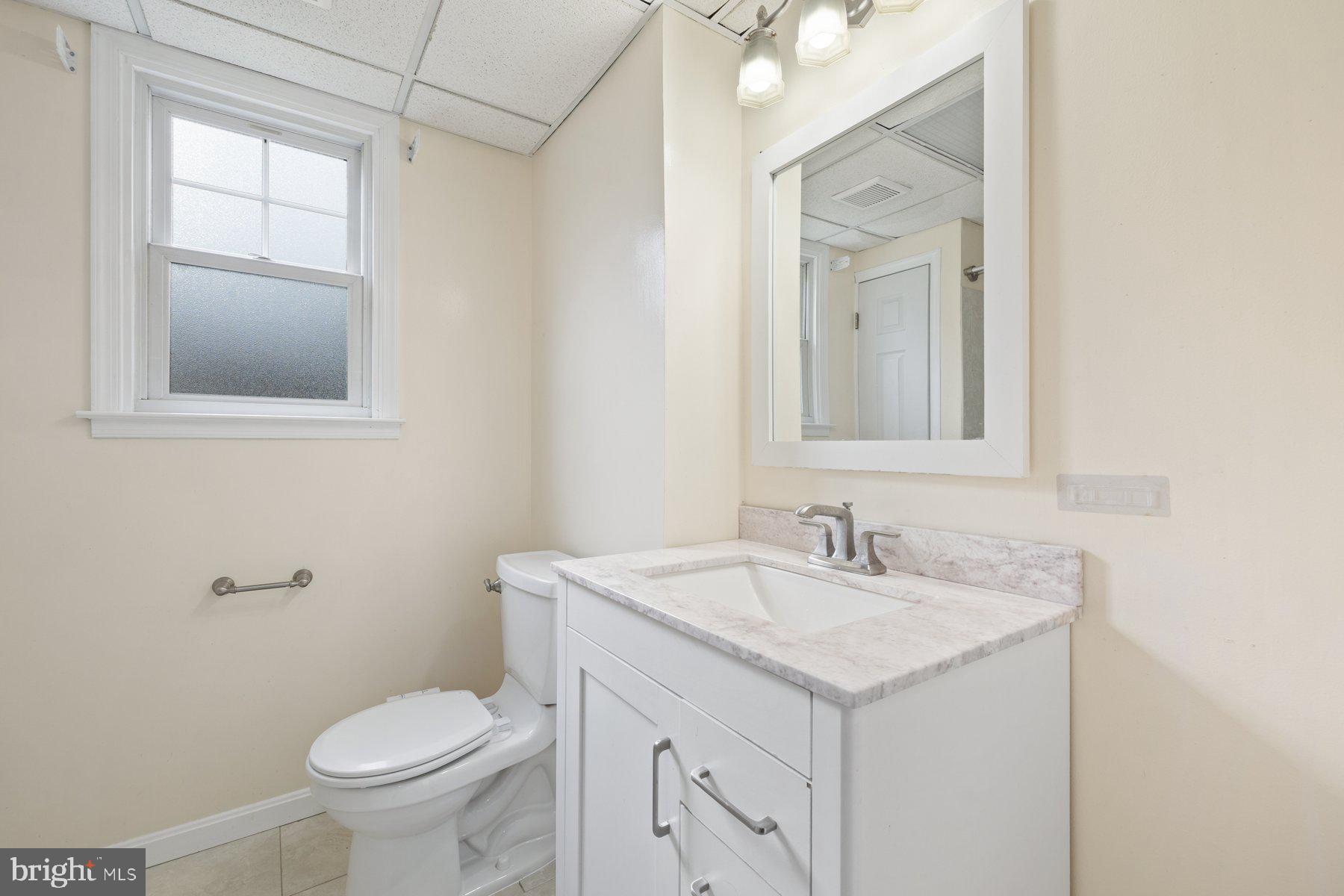 1302 Squire Lane Dunkirk, MD 20754 - Photo 22 of 31 a bathroom with a sink toilet and mirror