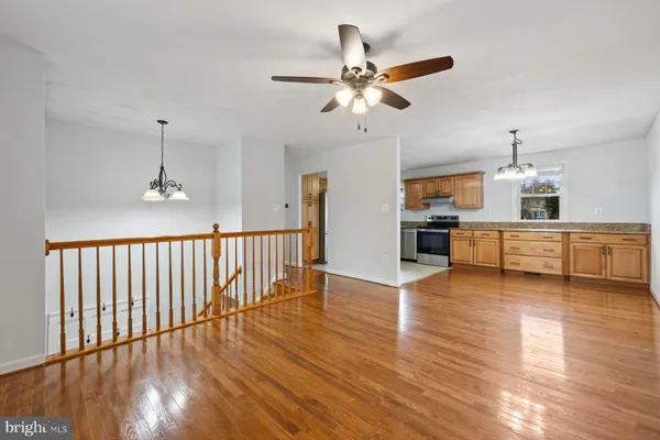 a view of a room with wooden floor and staircase