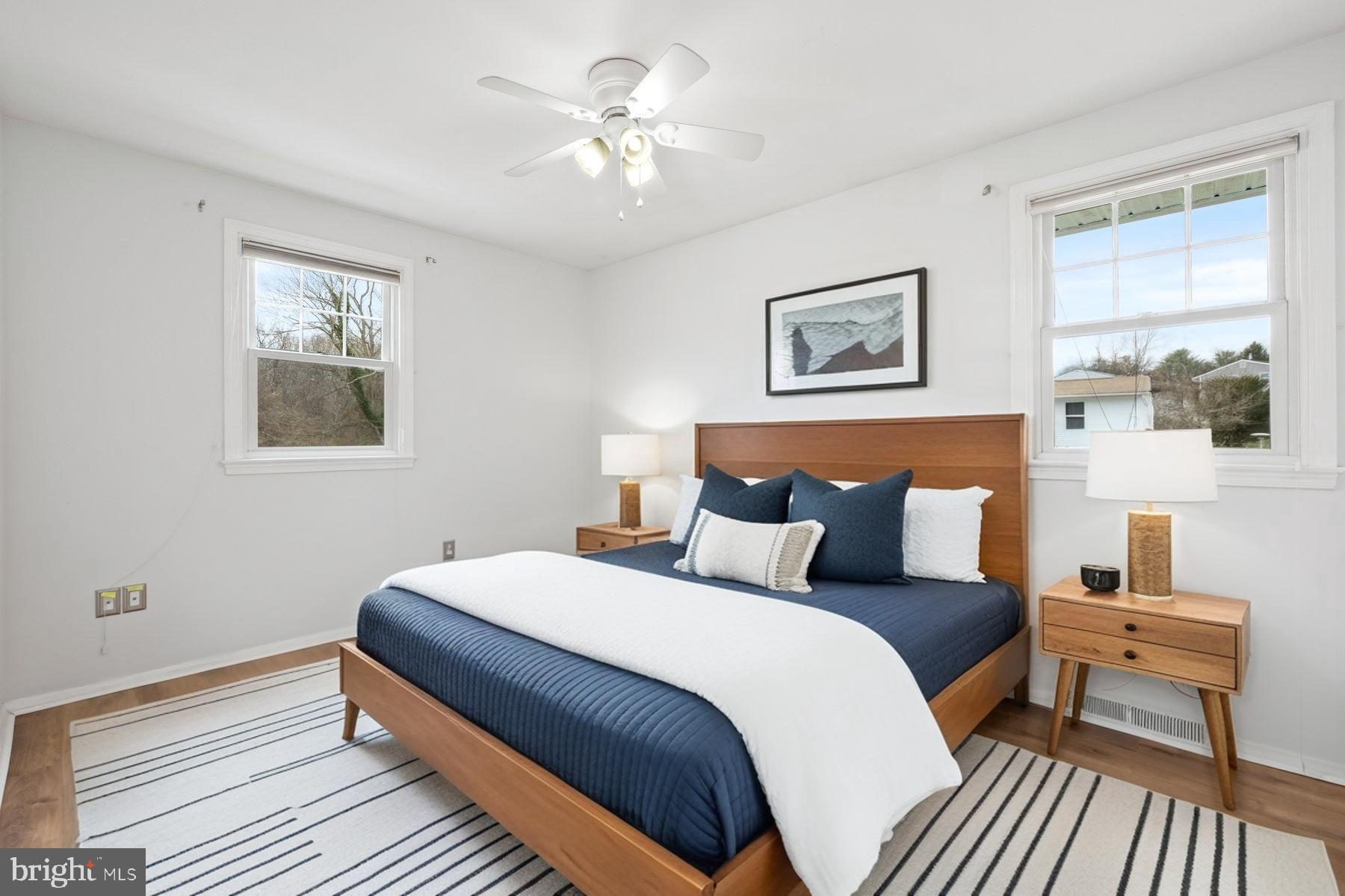 1302 Squire Lane Dunkirk, MD 20754 - Photo 7 of 31 a bedroom with a bed and a lamp on dresser with wooden floor