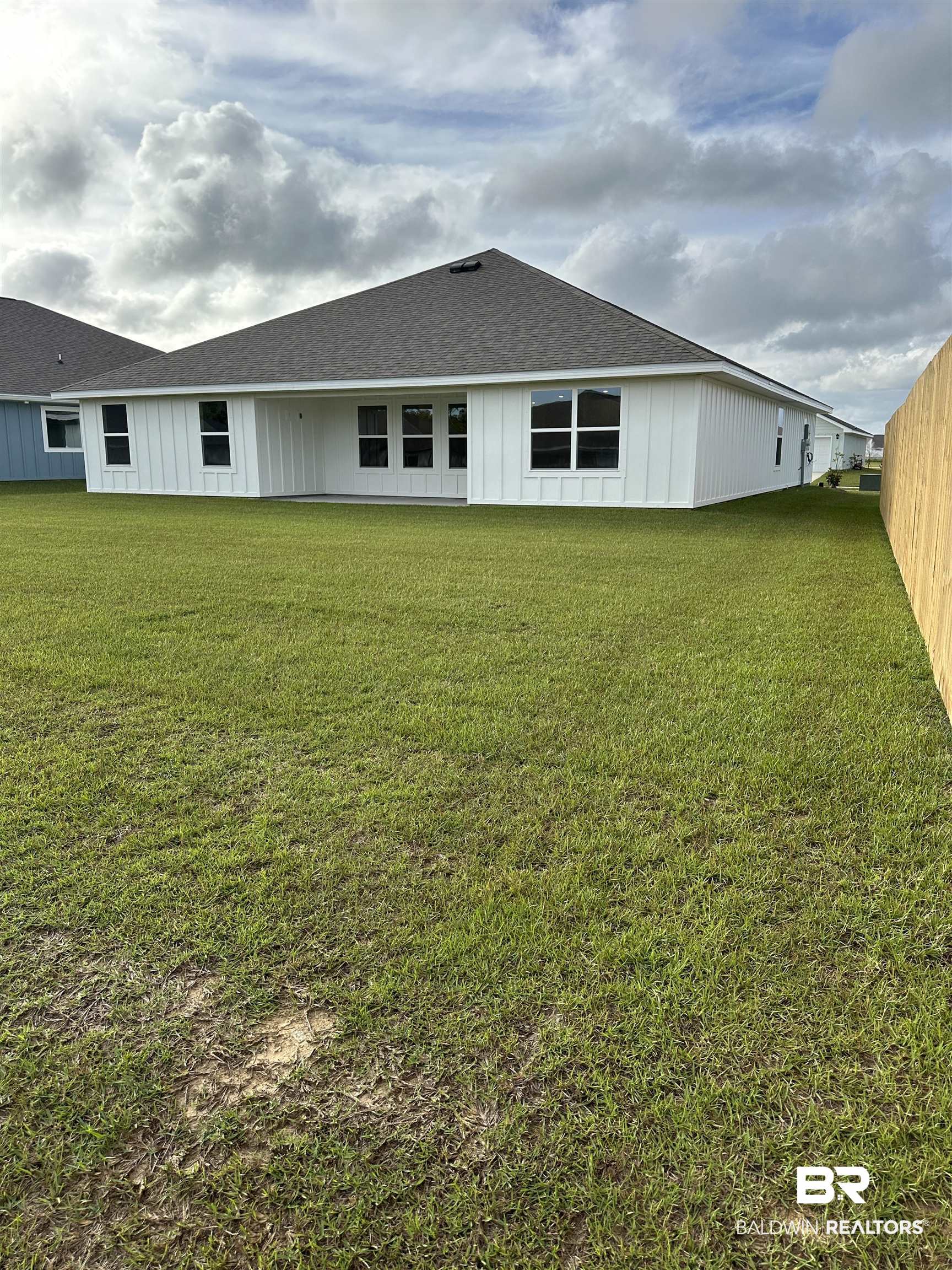 8850 Sea Star Circle Foley, AL 36535 - Photo 11 of 29 Back of house featuring a lawn