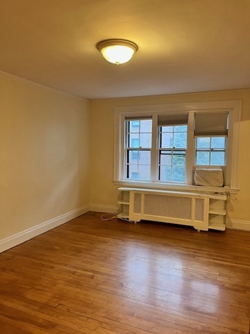 12 Aberdeen Street, Unit 2 Boston, MA 02215 - Photo 1 of 9 a view of an empty room with a window and wooden floor
