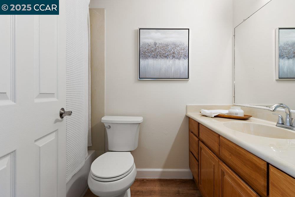 4081 Clayton Road, Unit 218 Concord, CA 94521 - Photo 14 of 26 a bathroom with a toilet a sink and mirror