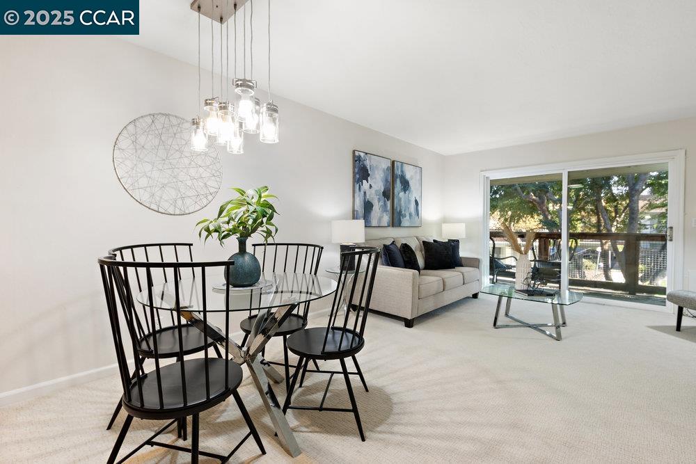 4081 Clayton Road, Unit 218 Concord, CA 94521 - Photo 2 of 26 a view of a dining room with furniture a chandelier and wooden floor