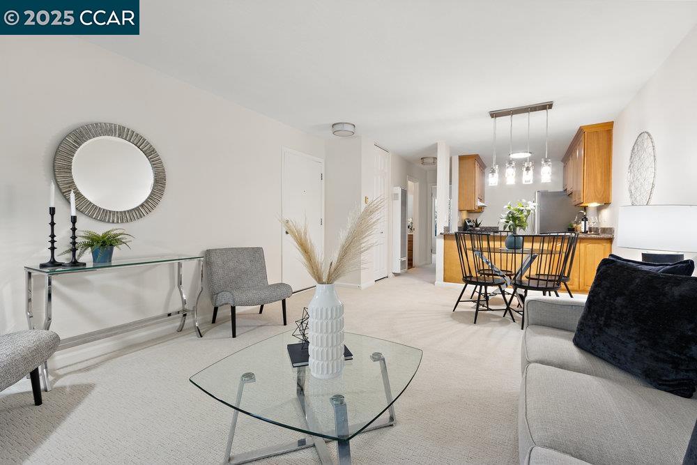4081 Clayton Road, Unit 218 Concord, CA 94521 - Photo 6 of 26 a living room with couches a coffee table and piano table