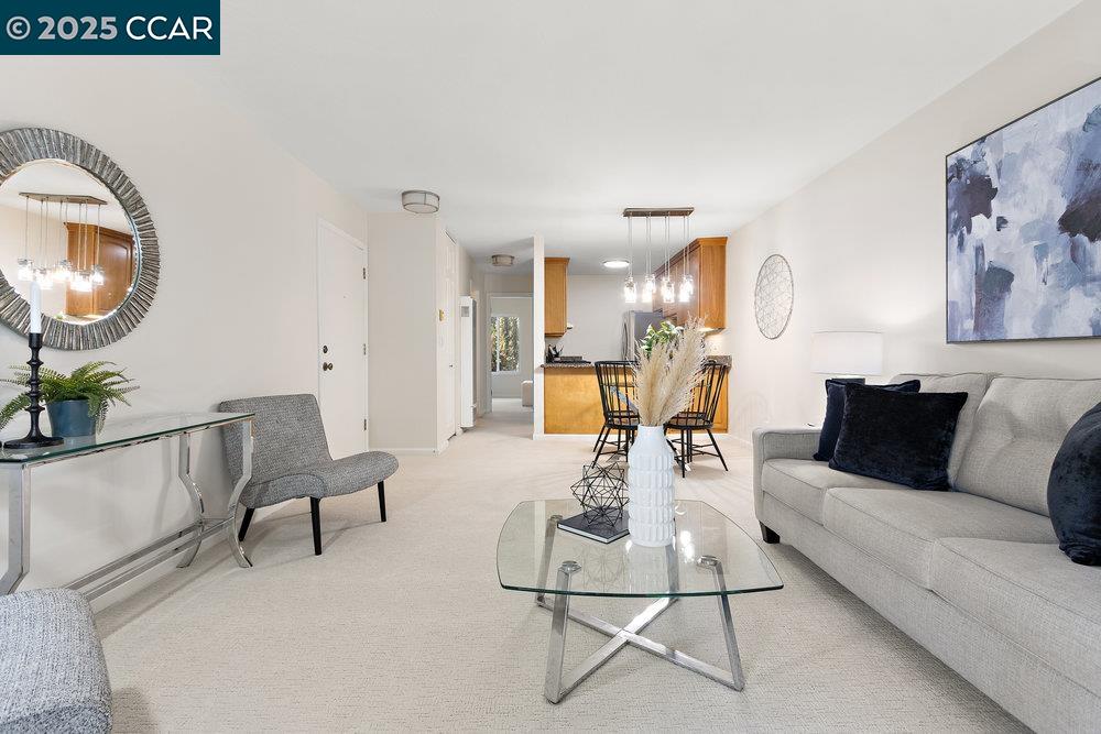 4081 Clayton Road, Unit 218 Concord, CA 94521 - Photo 7 of 26 a living room with furniture and a mirror