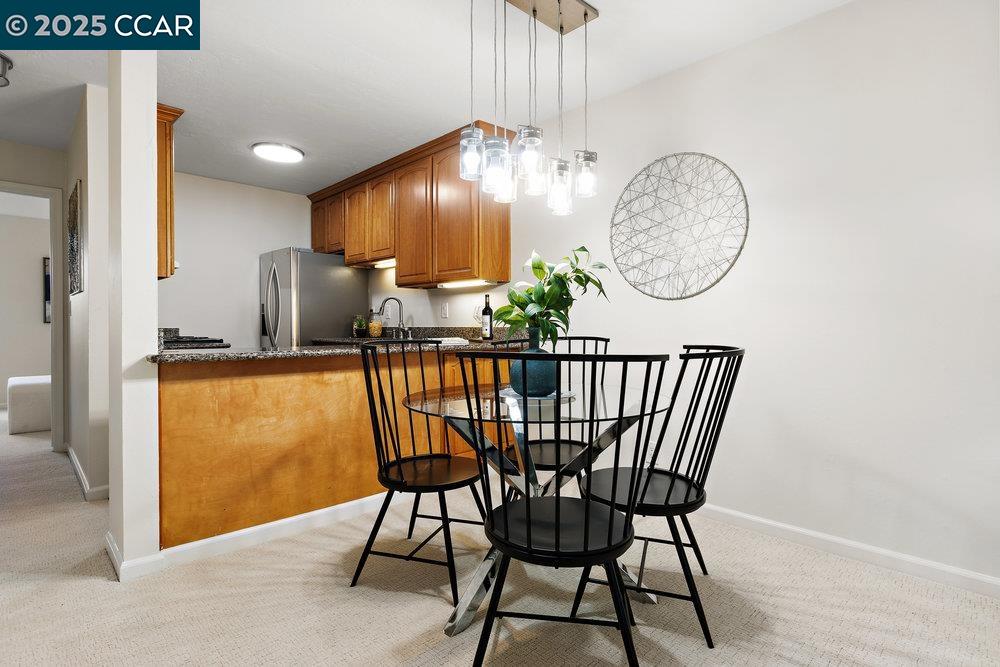 4081 Clayton Road, Unit 218 Concord, CA 94521 - Photo 8 of 26 a dining room with furniture and chandelier fan