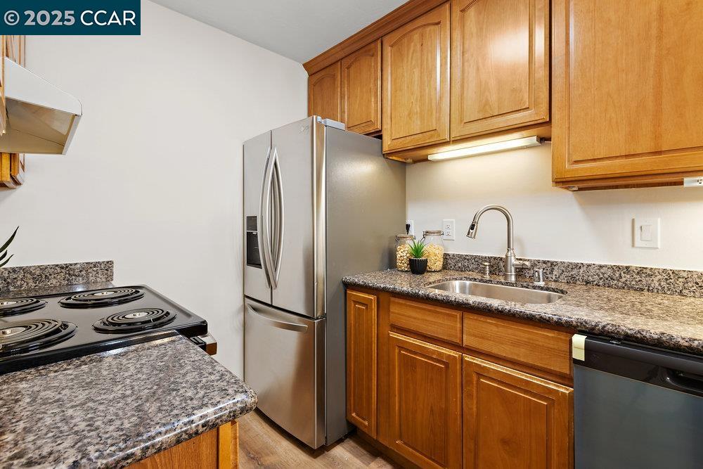 4081 Clayton Road, Unit 218 Concord, CA 94521 - Photo 9 of 26 a kitchen with stainless steel appliances granite countertop a sink stove and refrigerator