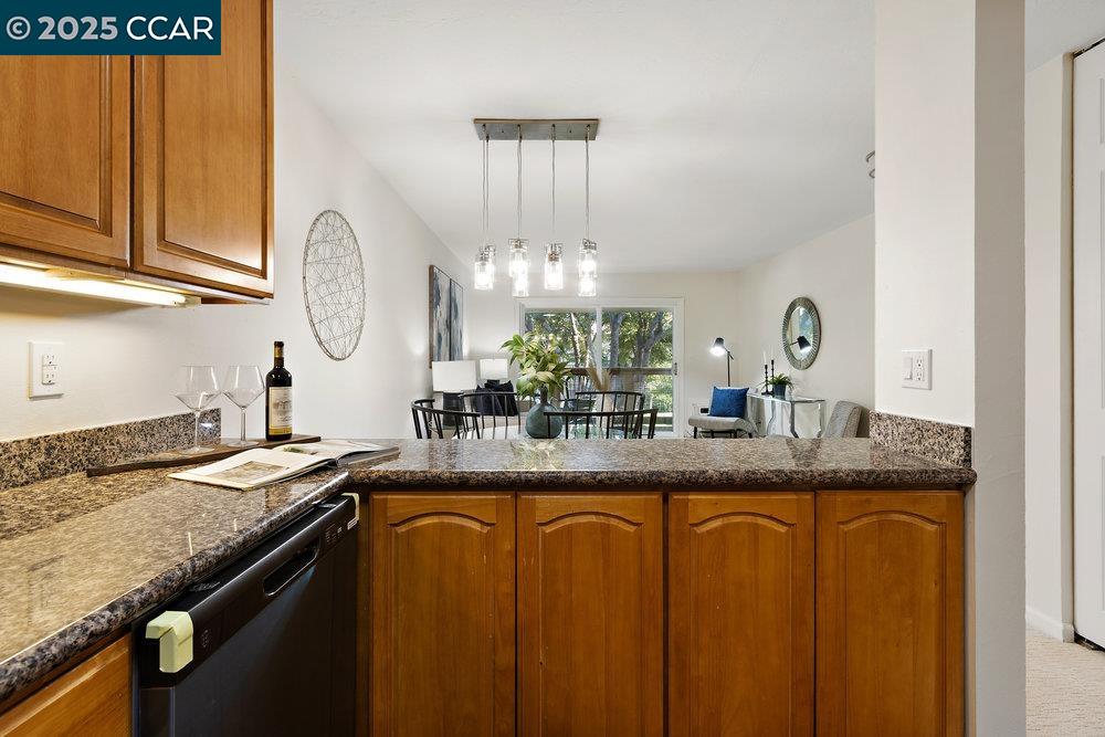 4081 Clayton Road, Unit 218 Concord, CA 94521 - Photo 10 of 26 a kitchen with granite countertop a sink a stove and cabinets