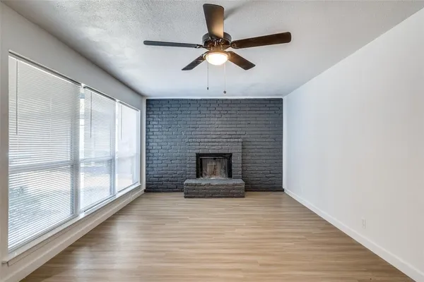 a kitchen with a refrigerator and white cabinets