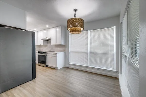 a kitchen with a refrigerator and cabinets
