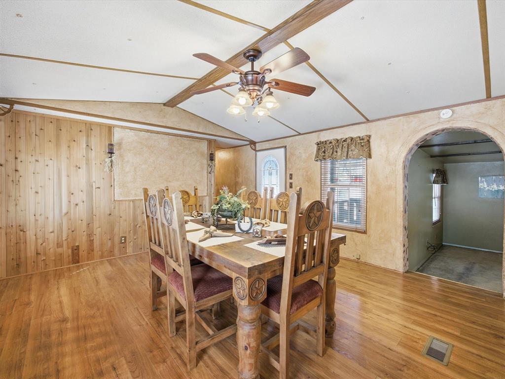 196 Perch Road Bowie, TX 76230 - Photo 4 of 33 a view of a dining room with furniture and wooden floor